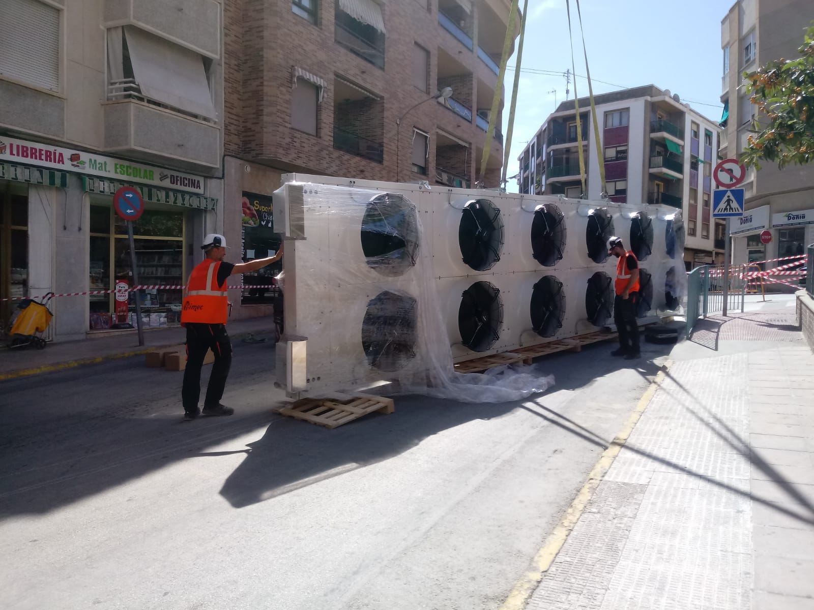Grúa instalando un condensador de gran tamaño en obra, Alicante